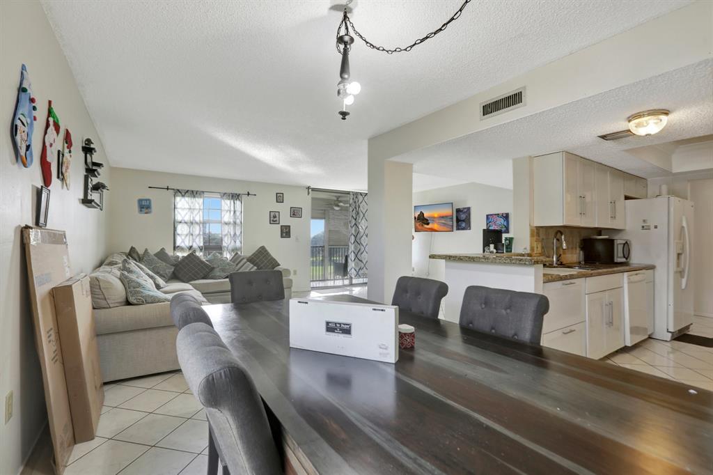 5570 Northwest 44th Street, Unit 518A Tamarac, FL 33319 - Photo 9 of 28 a living room with furniture and kitchen view