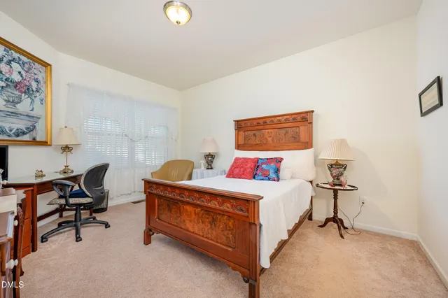 a bedroom with a bed and a desk