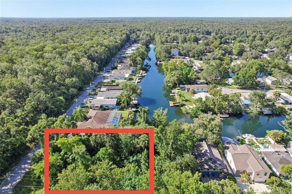 6945 East Richard Drive Weeki Wachee, FL 34607 - Photo 1 of 1 an aerial view of residential houses with outdoor space and lake view