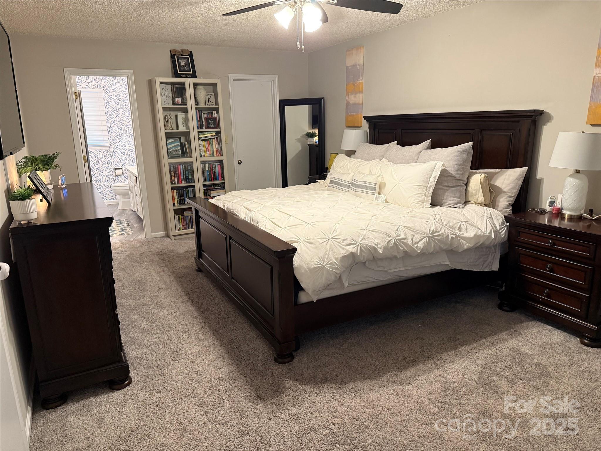 1209 Derbyshire Road Kannapolis, NC 28081 - Photo 11 of 19 a bedroom with a bed and a chandelier