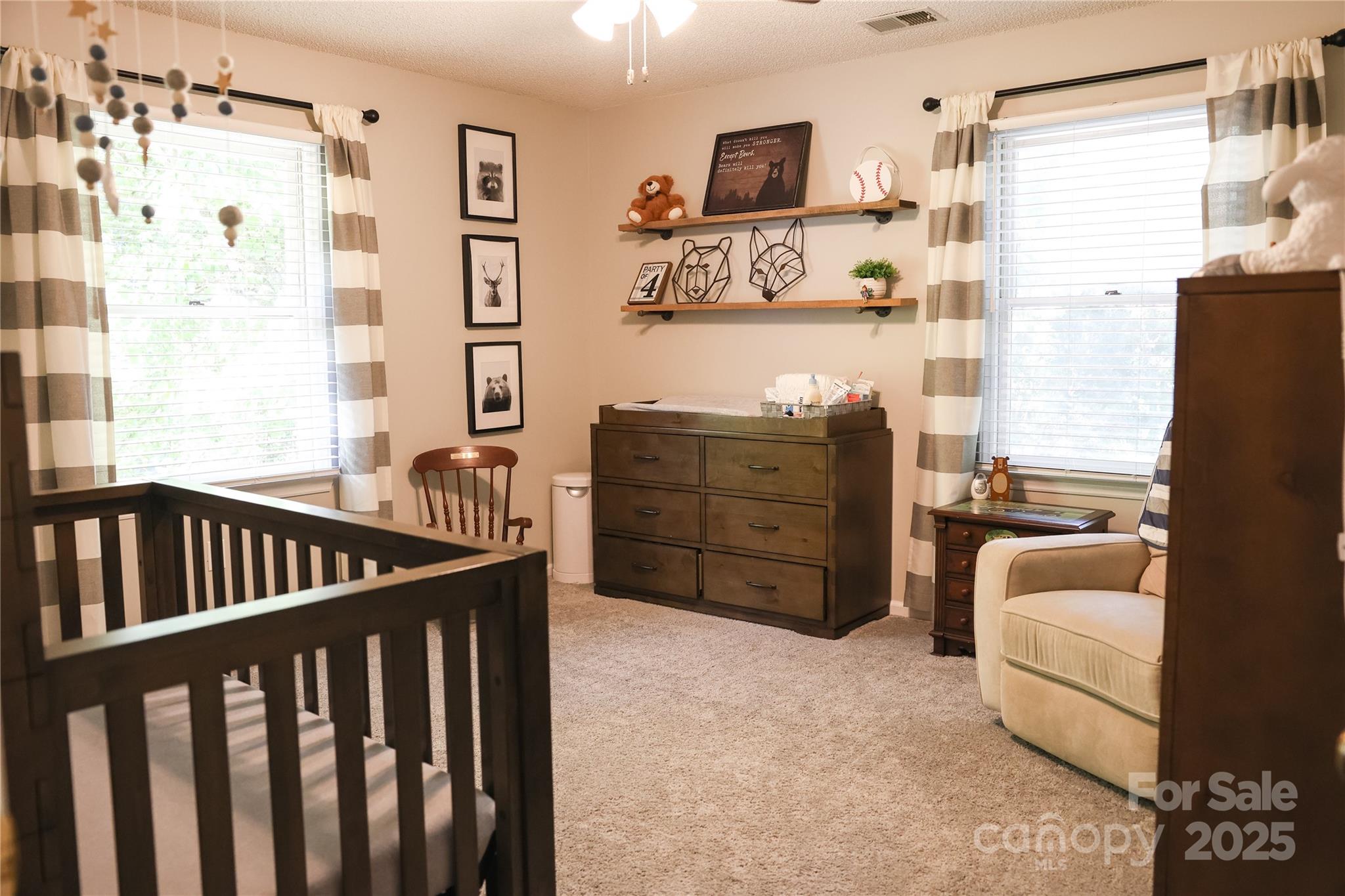 1209 Derbyshire Road Kannapolis, NC 28081 - Photo 13 of 19 a bedroom with furniture and baby crib