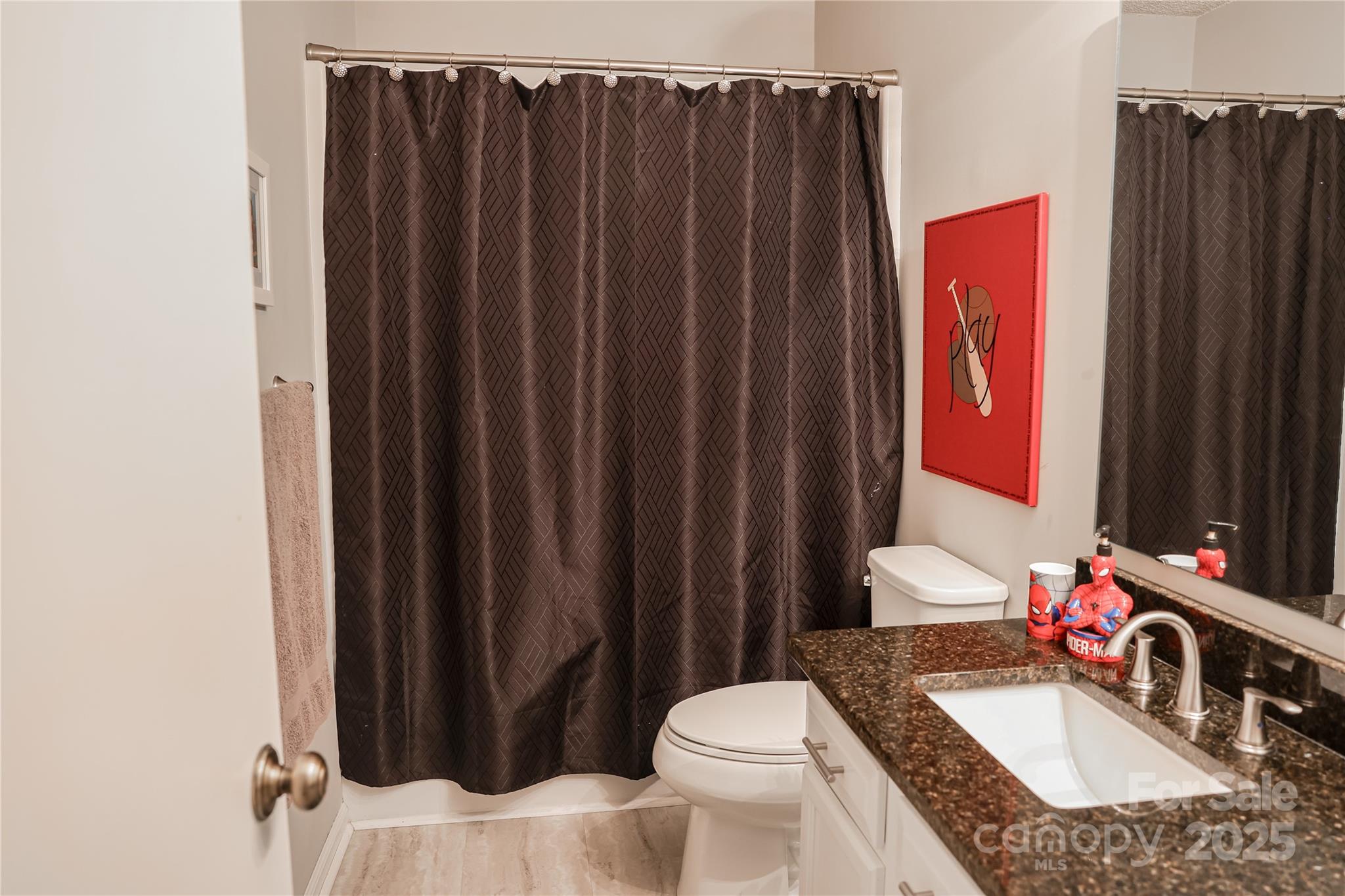 1209 Derbyshire Road Kannapolis, NC 28081 - Photo 15 of 19 a bathroom with a granite countertop sink vanity mirror and toilet
