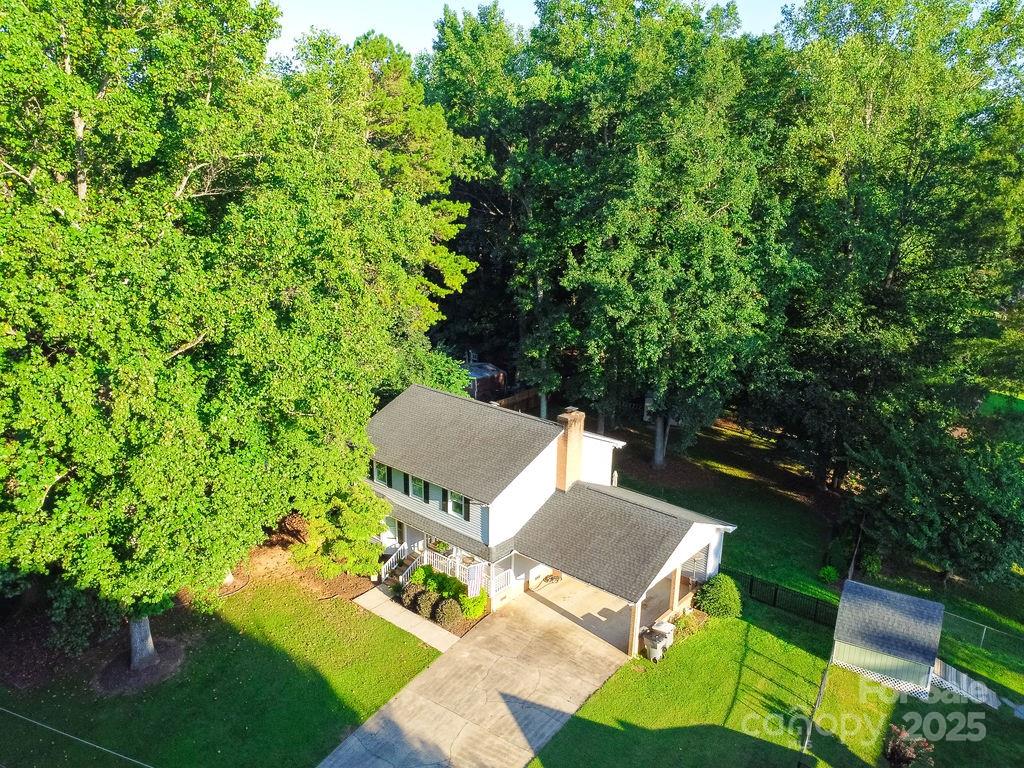 1209 Derbyshire Road Kannapolis, NC 28081 - Photo 19 of 19 a view of a patio with table and chairs and potted plants
