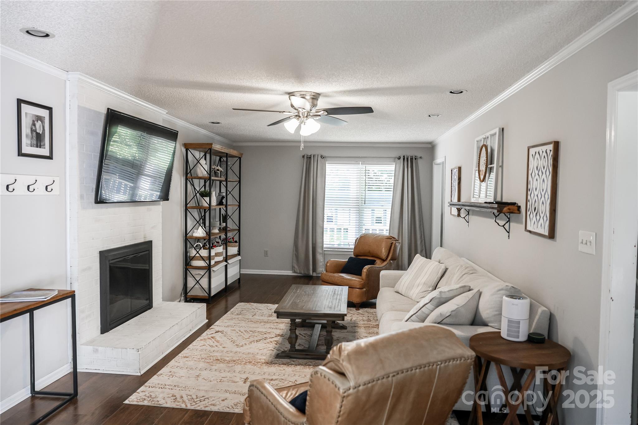 1209 Derbyshire Road Kannapolis, NC 28081 - Photo 4 of 19 a living room with furniture a fireplace and a flat screen tv