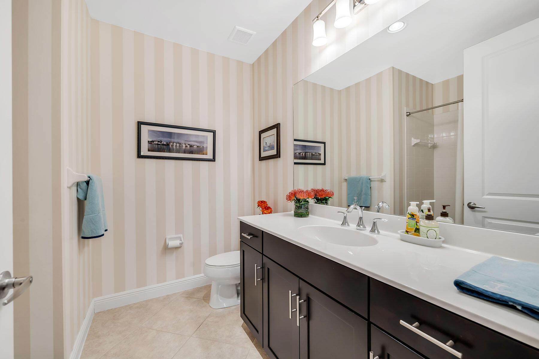 3783 Canopy Circle Naples, FL 34120 - Photo 21 of 39 a bathroom with a double vanity sink a toilet and a mirror