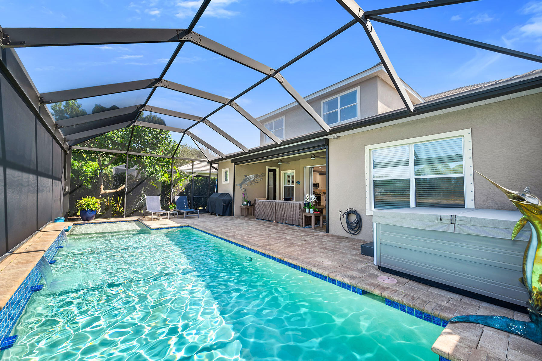 3783 Canopy Circle Naples, FL 34120 - Photo 29 of 39 a view of a backyard with table and chairs under an umbrella