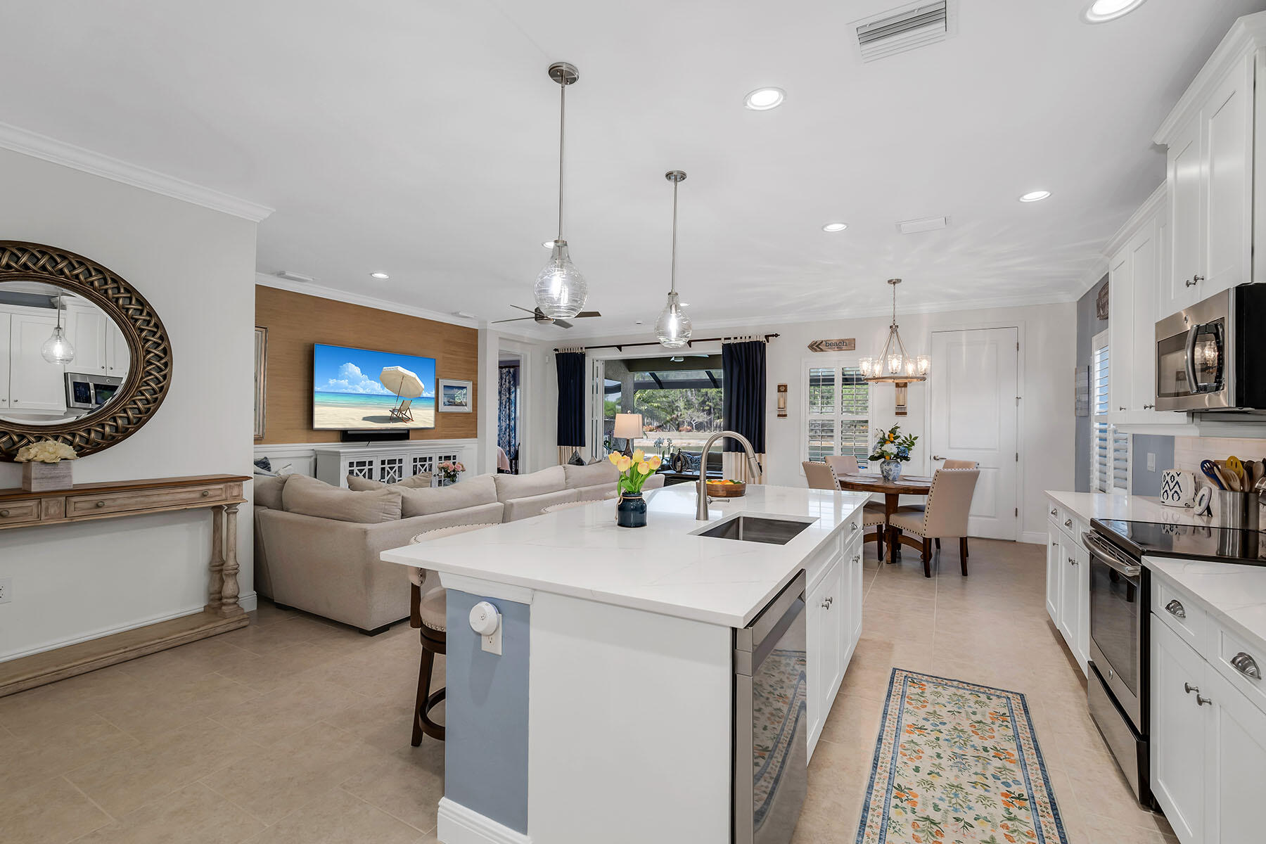 3783 Canopy Circle Naples, FL 34120 - Photo 6 of 39 a kitchen with a sink stove and cabinets