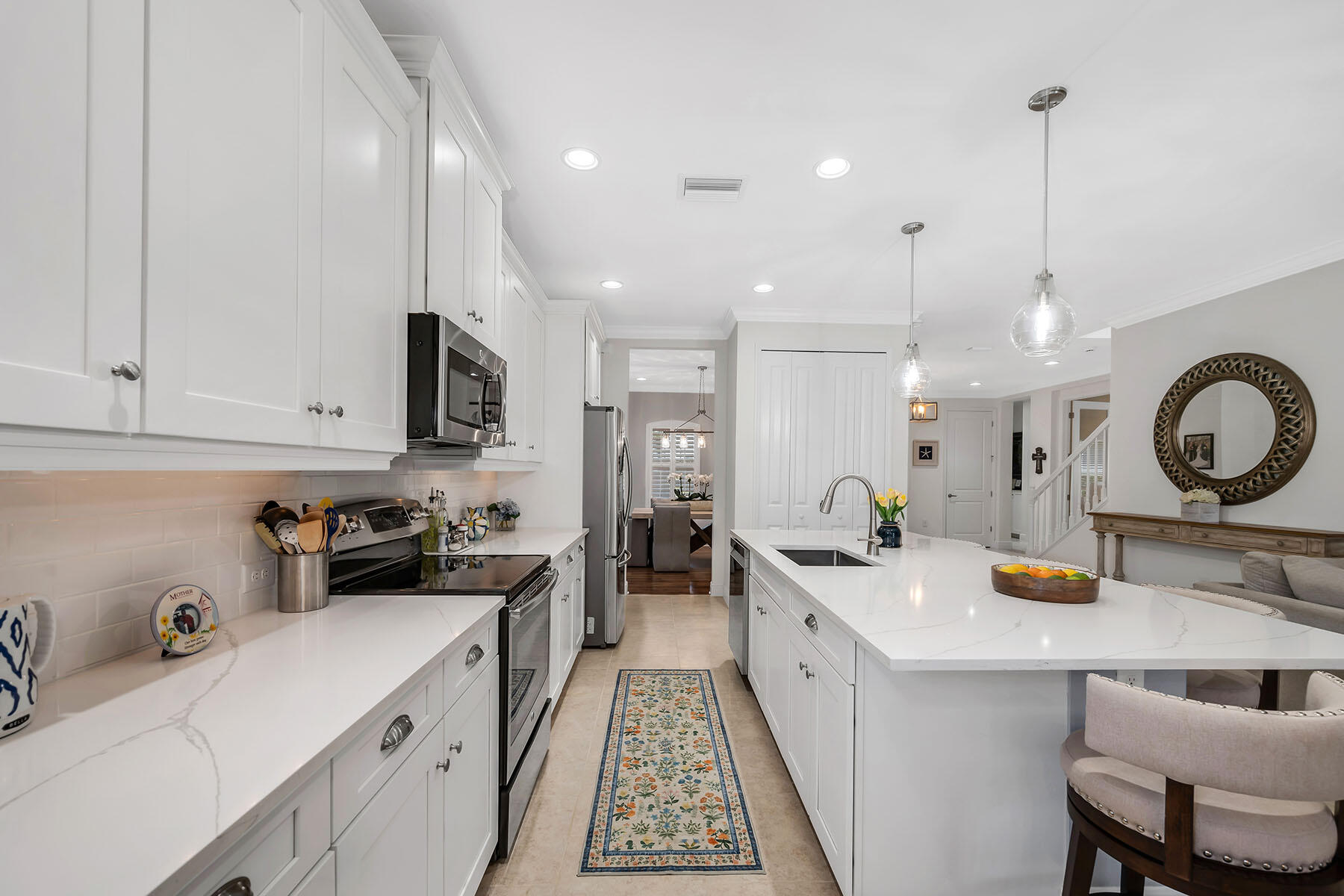 3783 Canopy Circle Naples, FL 34120 - Photo 7 of 39 a kitchen with a sink stove and cabinets
