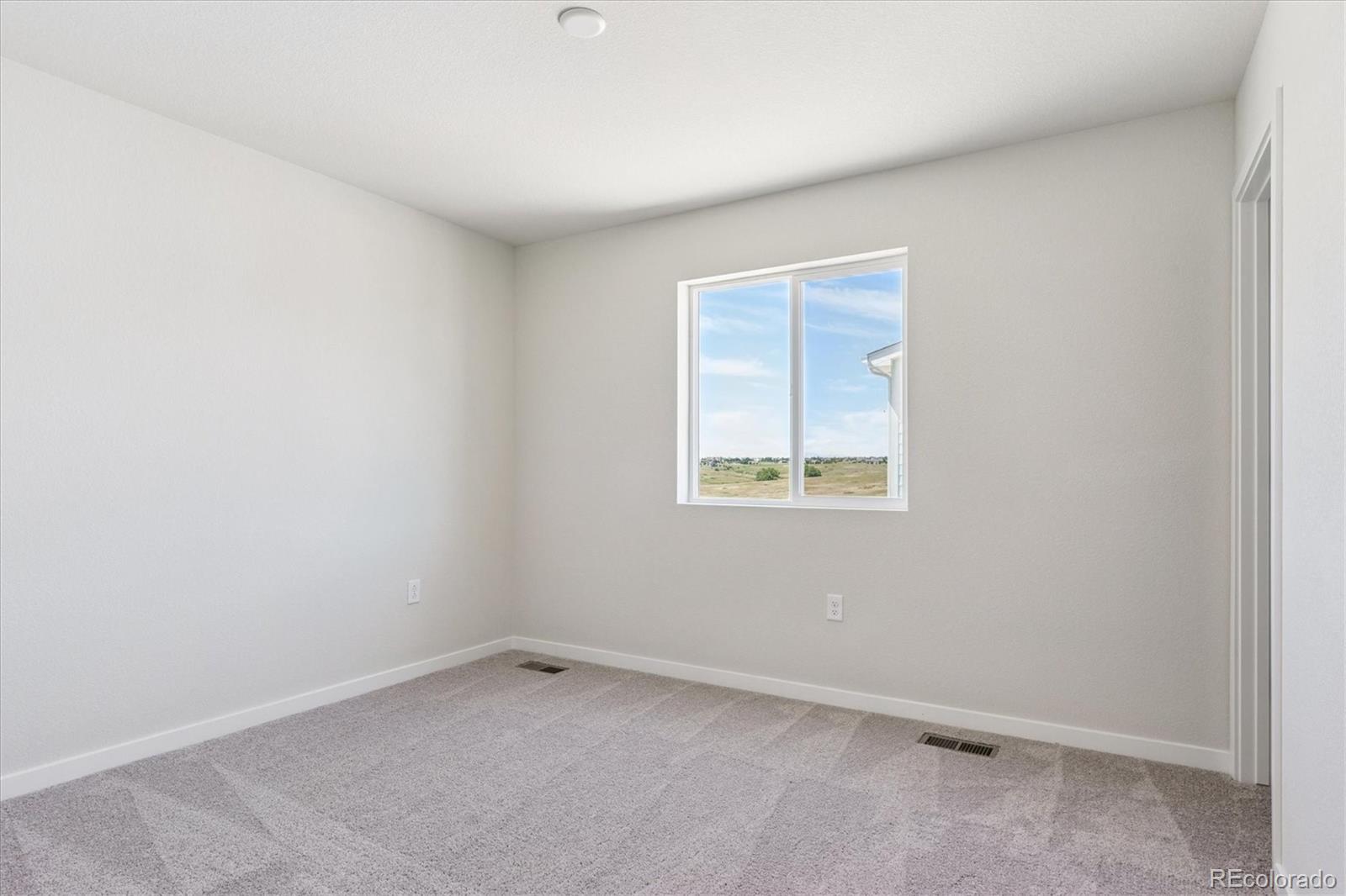 4235 Gozzer Ranch Drive Elizabeth, CO 80107 - Photo 13 of 23 an empty room with a window