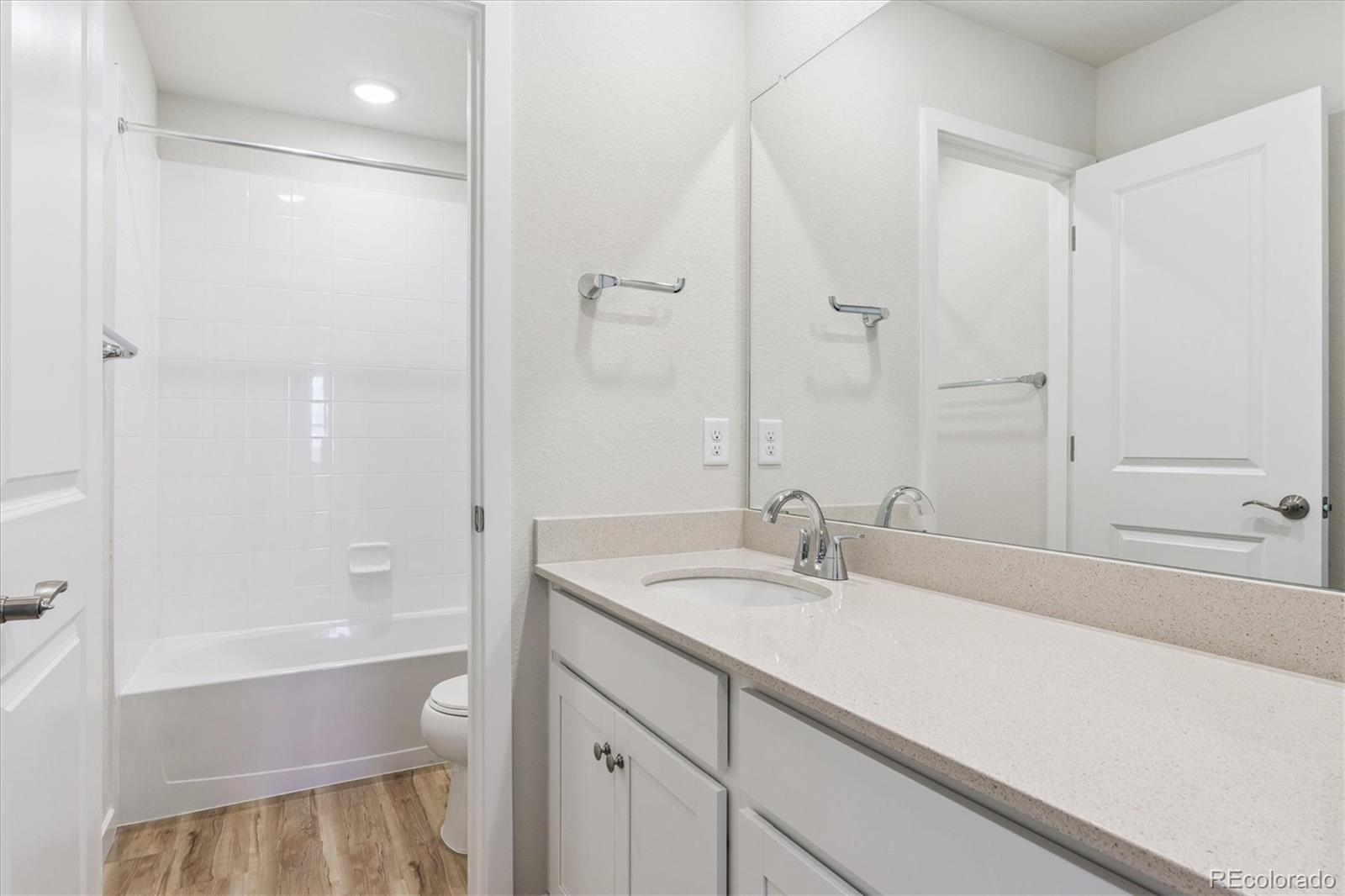 4235 Gozzer Ranch Drive Elizabeth, CO 80107 - Photo 15 of 23 a bathroom with a sink and a mirror with bathtub