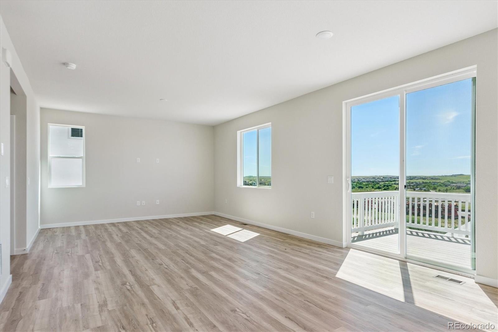 4235 Gozzer Ranch Drive Elizabeth, CO 80107 - Photo 7 of 23 a view of an empty room with wooden floor and a window
