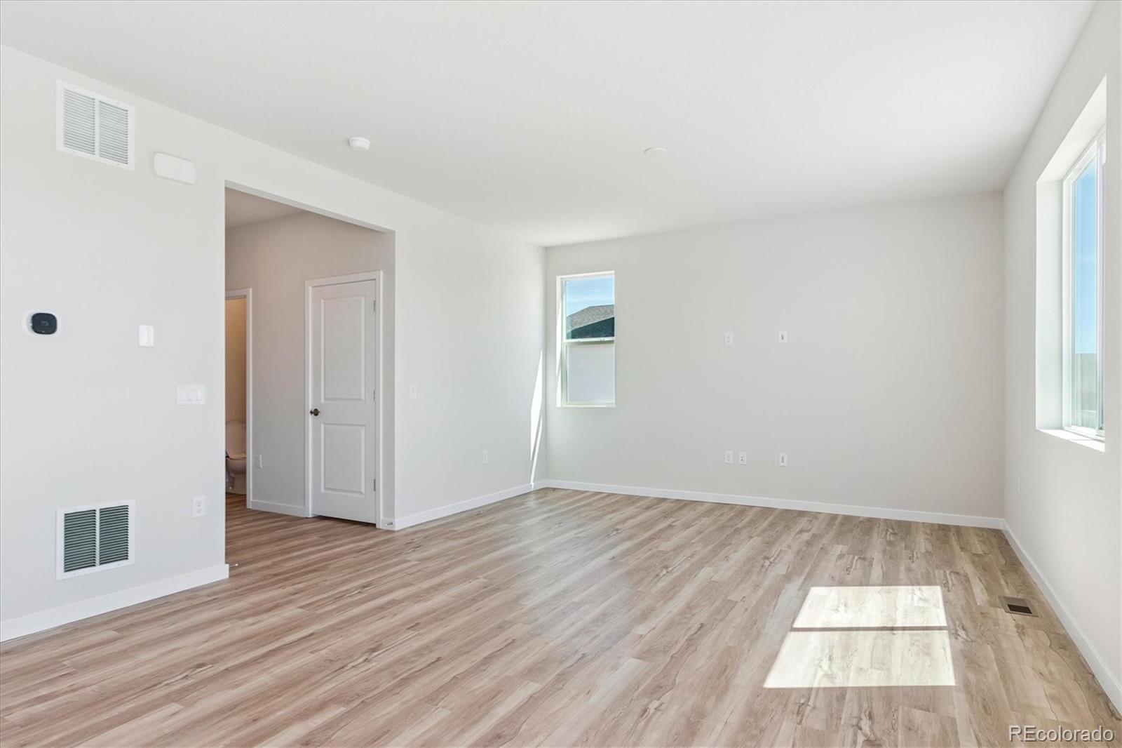 4235 Gozzer Ranch Drive Elizabeth, CO 80107 - Photo 8 of 23 an empty room with wooden floor and windows