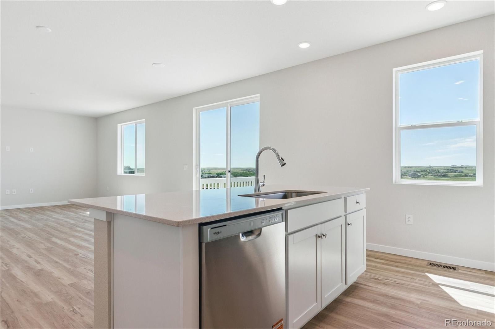 4235 Gozzer Ranch Drive Elizabeth, CO 80107 - Photo 9 of 23 a kitchen with a sink cabinets and wooden floor