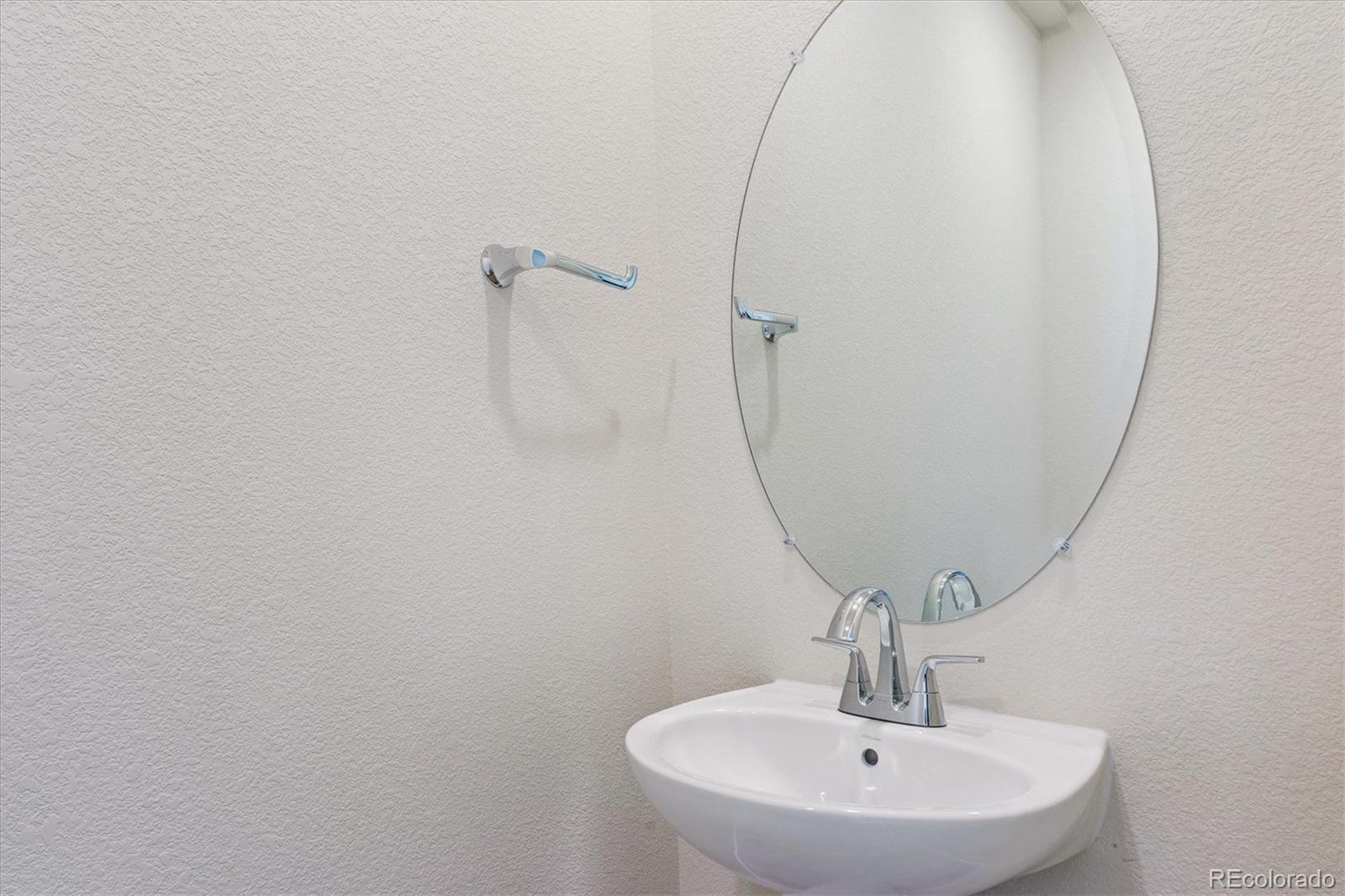 4235 Gozzer Ranch Drive Elizabeth, CO 80107 - Photo 10 of 23 a bathroom with a sink and mirror