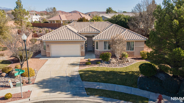 1102 North 2130 W Street St. George, UT 84770 - Photo 1 of 1 Mediterranean / spanish-style home featuring concrete driveway, a garage, stucco siding, and a tile roof