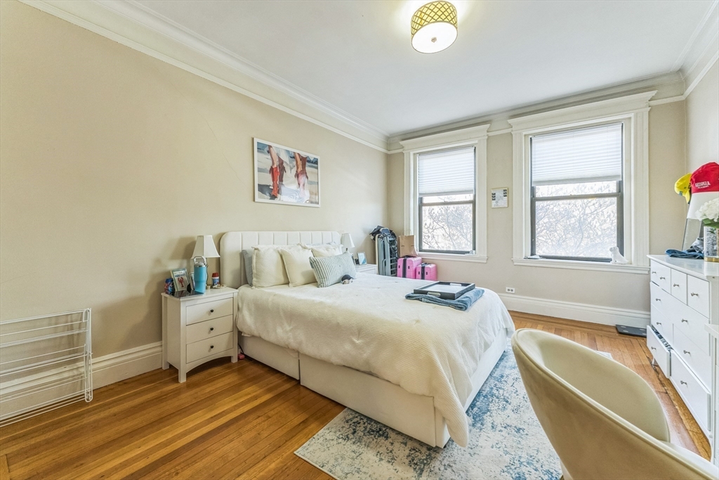 466 Commonwealth Avenue, Unit 301 Boston, MA 02215 - Photo 3 of 14 a bedroom with a bed and a large window