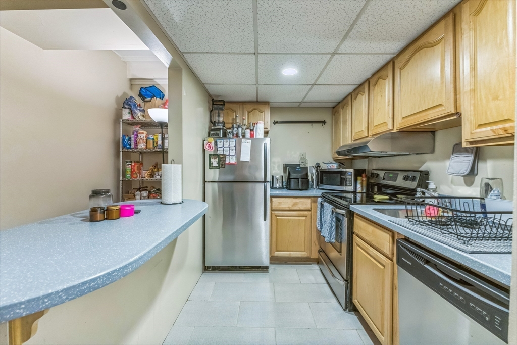 466 Commonwealth Avenue, Unit 301 Boston, MA 02215 - Photo 6 of 14 a kitchen with refrigerator and cabinets