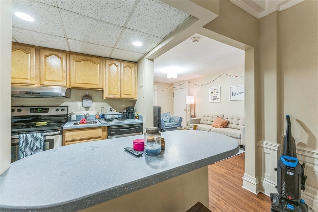 466 Commonwealth Avenue, Unit 301 Boston, MA 02215 - Photo 7 of 14 a kitchen with sink a stove and cabinets