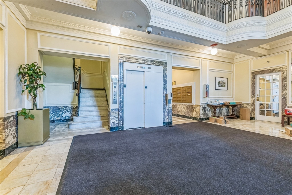 466 Commonwealth Avenue, Unit 301 Boston, MA 02215 - Photo 10 of 14 a view of a hallway with a dining table and chairs