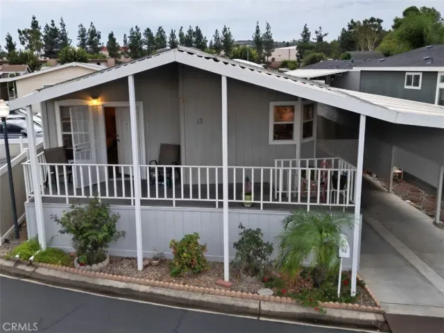 an aerial view of a house with a yard and potted plants