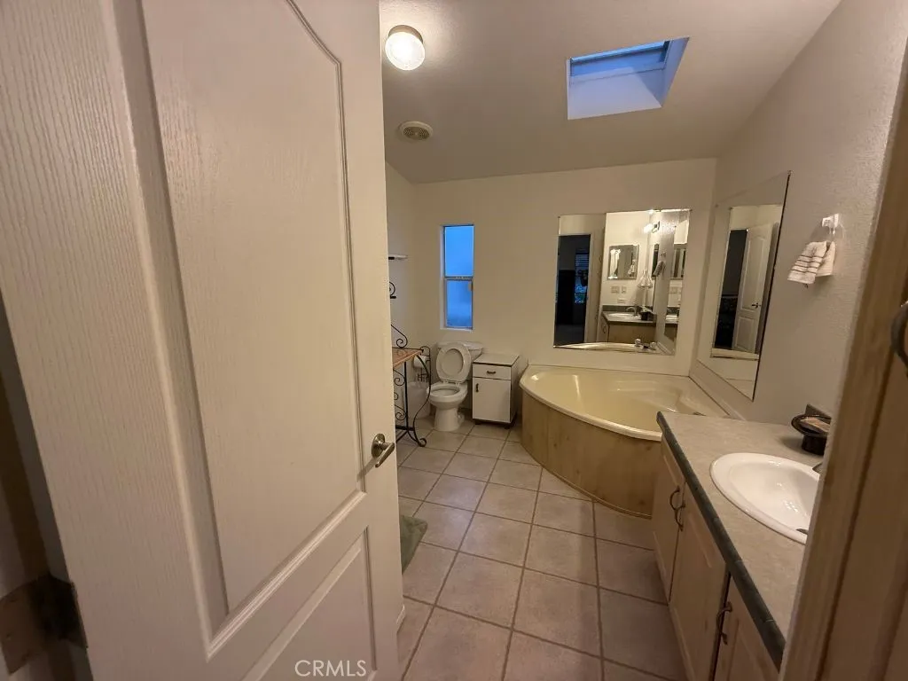 1001 South Hale, Unit 13 Escondido, CA 92025 - Photo 12 of 20 a bathroom with a sink a mirror and a toilet