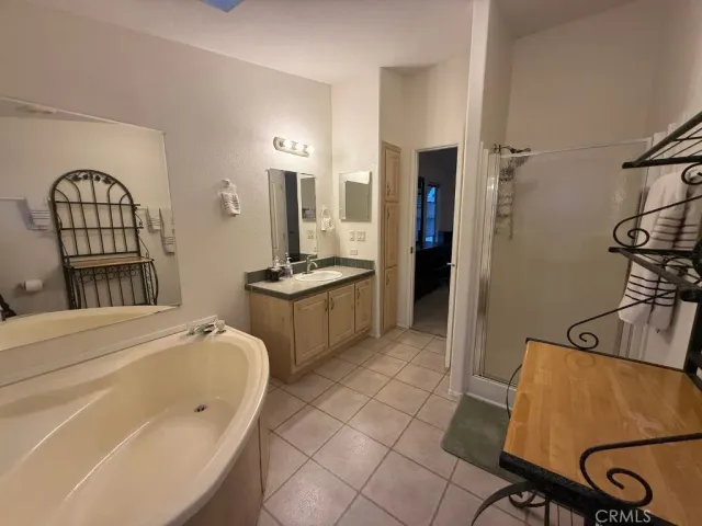 a spacious bedroom with a bed a couch and dresser