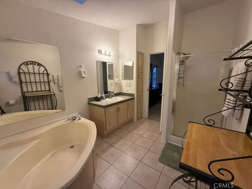 1001 South Hale, Unit 13 Escondido, CA 92025 - Photo 13 of 20 a spacious bedroom with a bed a couch and dresser