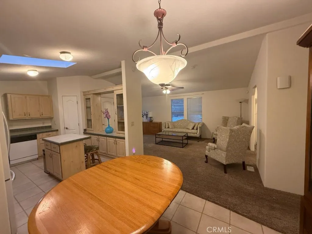 1001 South Hale, Unit 13 Escondido, CA 92025 - Photo 7 of 20 a living room with furniture a chandelier and kitchen view