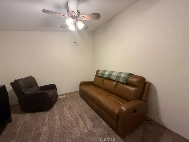 a white couch sitting in a living room with furniture