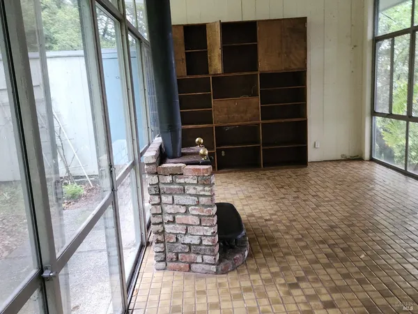 a view of walk in closet with empty racks