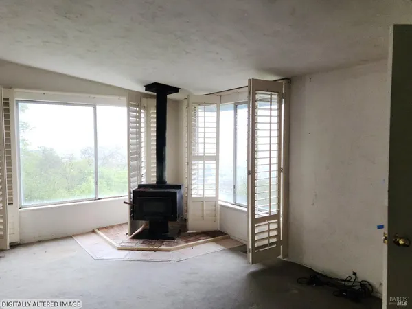 a living room with furniture and large windows