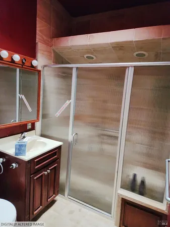 a bathroom with a sink a toilet and shower