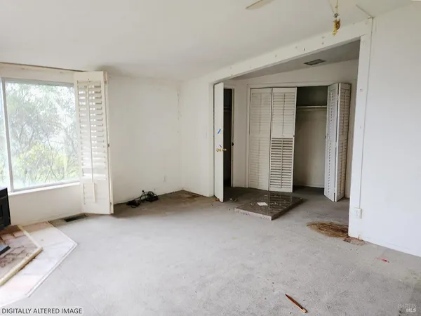 an empty room with windows and closet