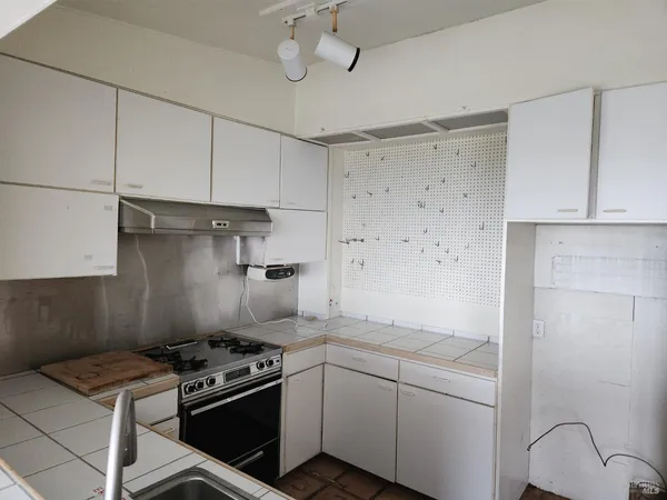 a kitchen with stainless steel appliances granite countertop a stove and a refrigerator
