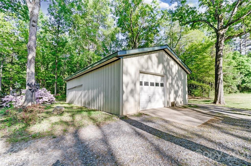 2579 Anderson Road South Catawba, SC 29704 - Photo 40 of 47 a backyard of a house with large trees and outdoor seating
