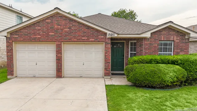 a view of a house with a small yard and plants