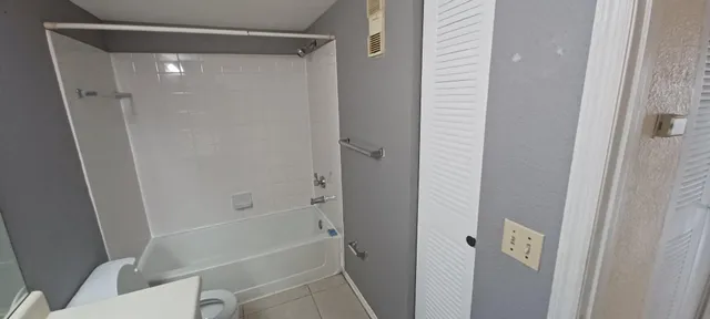 a bathroom with a shower and a toilet