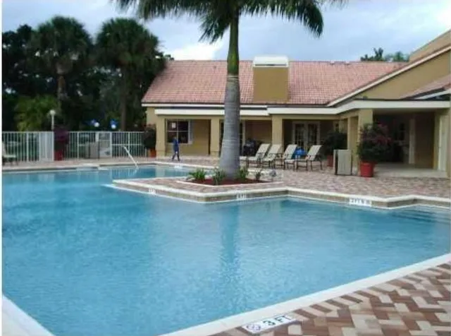 a front view of house with outdoor seating yard and swimming pool