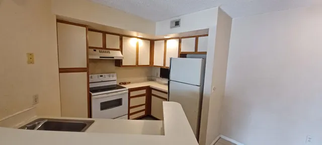a kitchen with stainless steel appliances a refrigerator and a sink