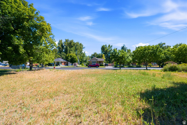 300 East S, Unit 2 Logan, UT 84321 - Photo 27 of 38 Expansive vacant lot featuring a mix of green and golden grasses