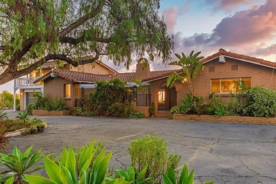 6778 West Lilac Road Bonsall, CA 92003 - Photo 1 of 45 a front view of a house with a garden