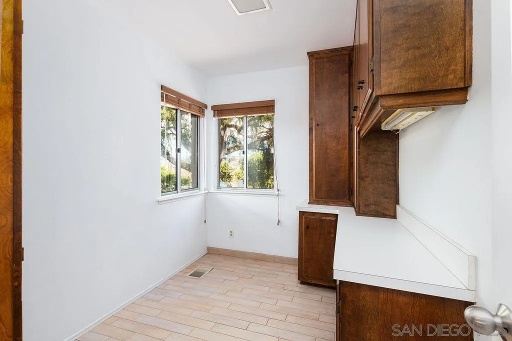 6778 West Lilac Road Bonsall, CA 92003 - Photo 18 of 45 a view of an empty room with wooden floor and a window