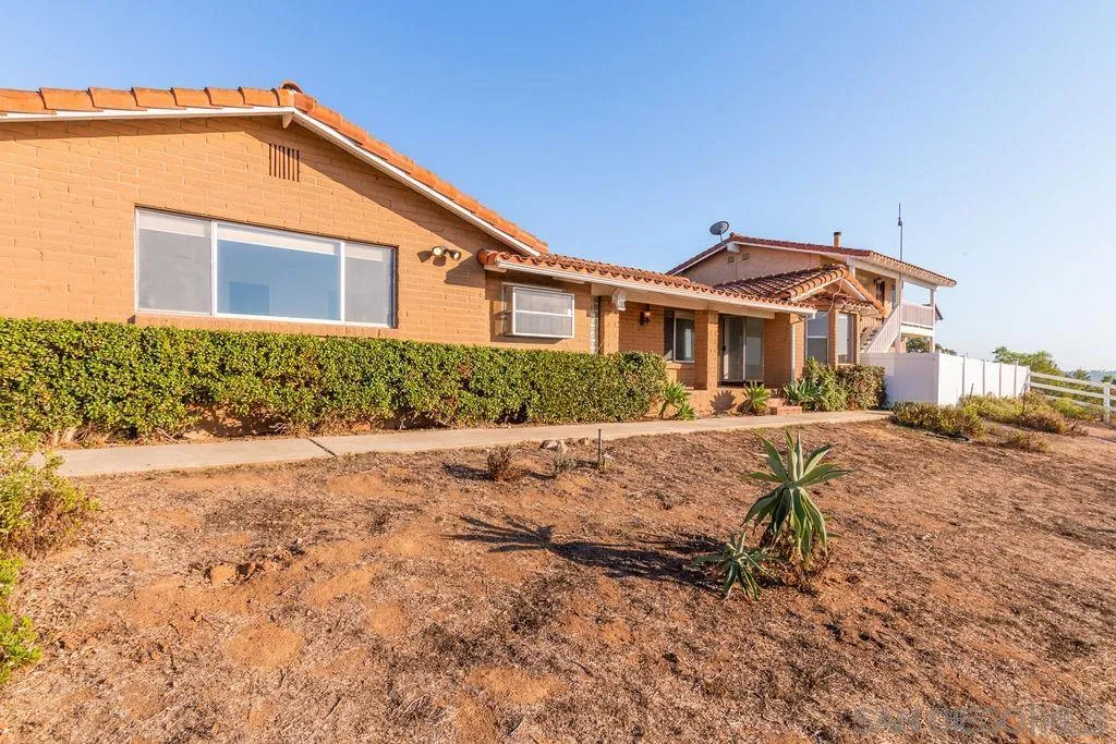 6778 West Lilac Road Bonsall, CA 92003 - Photo 35 of 45 a front view of a house with a yard