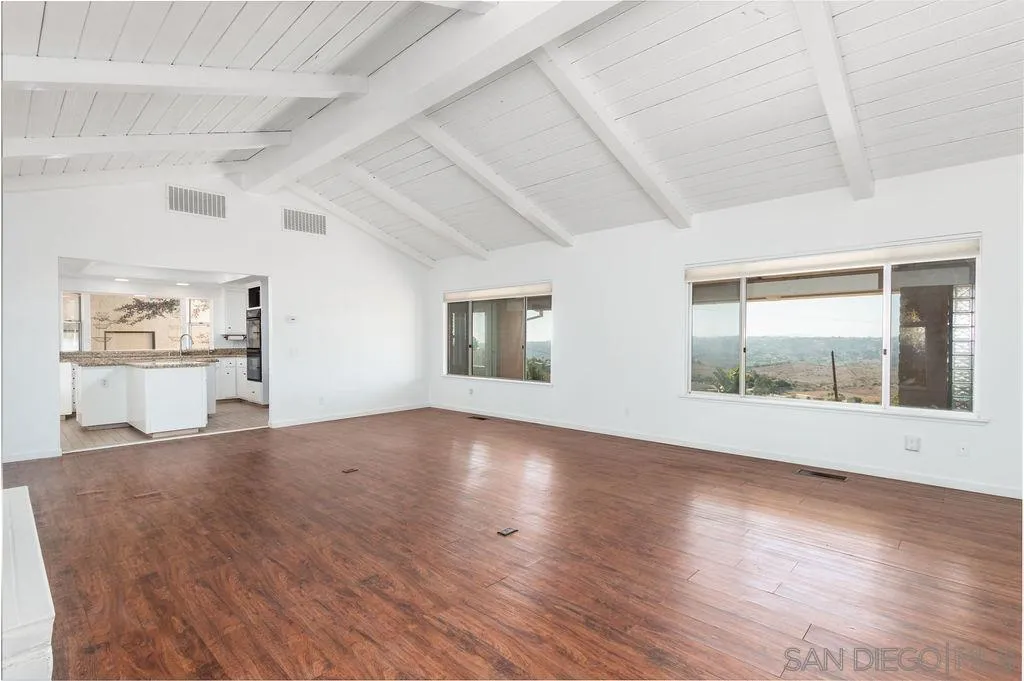 6778 West Lilac Road Bonsall, CA 92003 - Photo 7 of 45 an empty room with wooden floor and windows