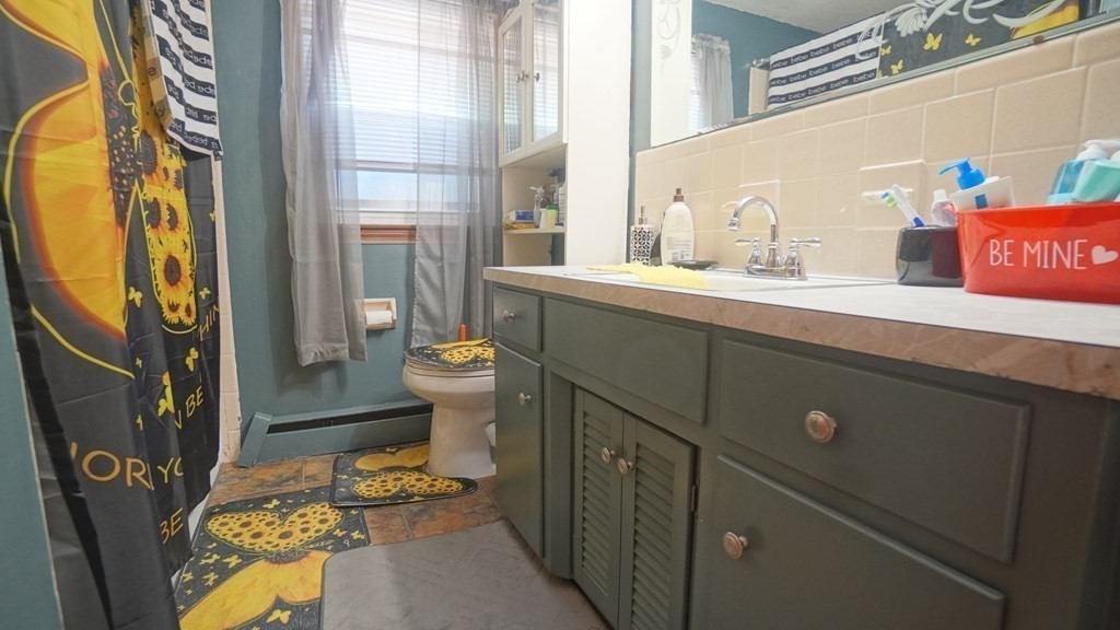 164 Prouty Street Springfield, MA 01119 - Photo 27 of 35 a bathroom with a sink mirror vanity and toilet