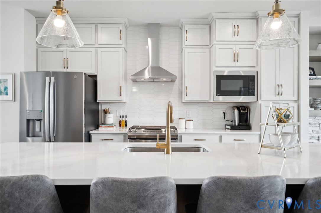 16108 Esteem Way Midlothian, VA 23113 - Photo 11 of 44 a kitchen with stainless steel appliances a stove a sink a refrigerator and a cabinets