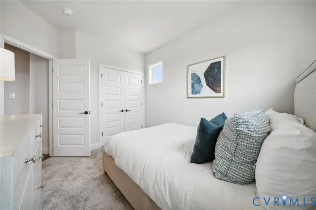 a bedroom with a bed and a wall painting