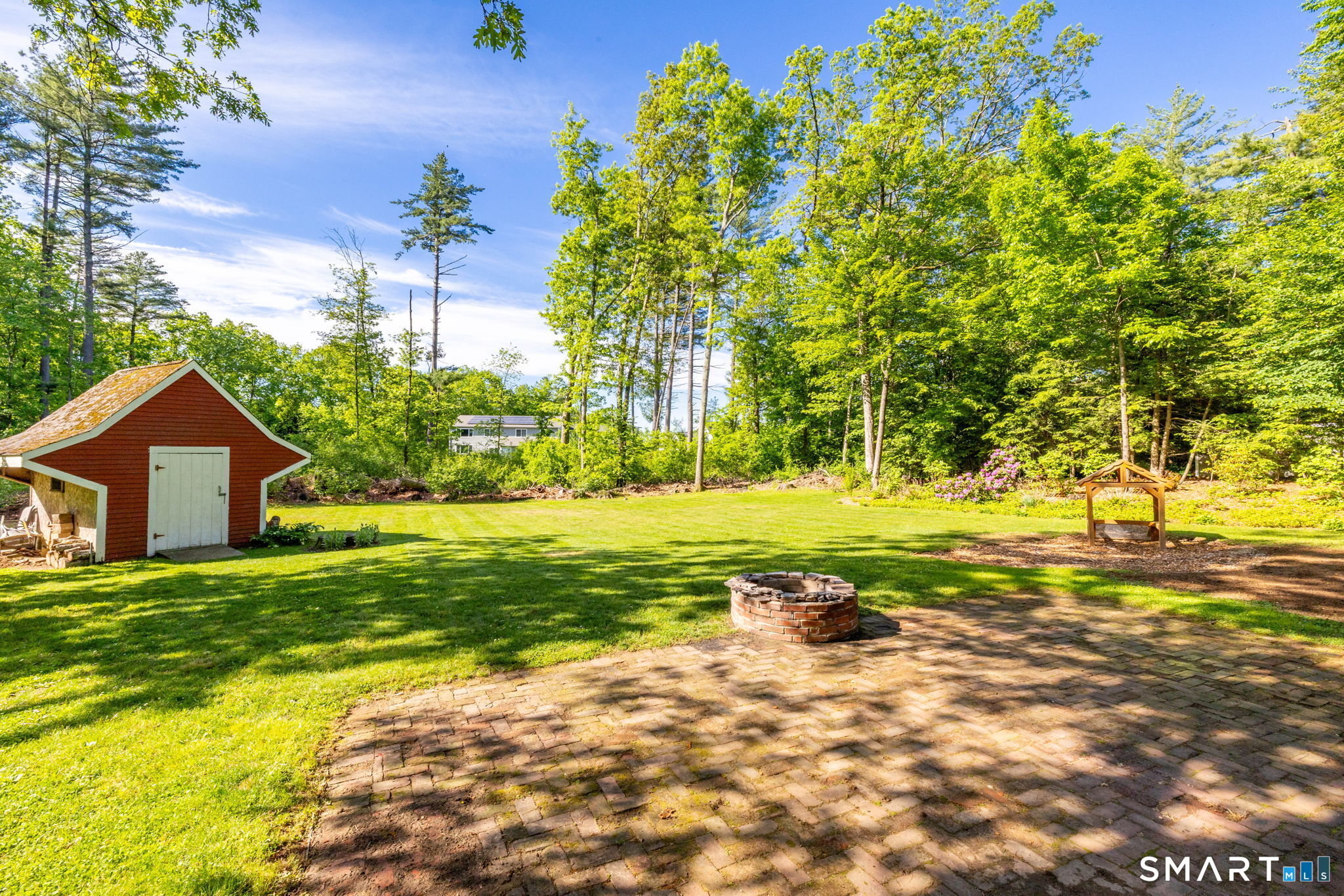 347 Griffin Road Suffield, CT 06093 - Photo 26 of 35 a view of a large garden with an outdoor space and seating area
