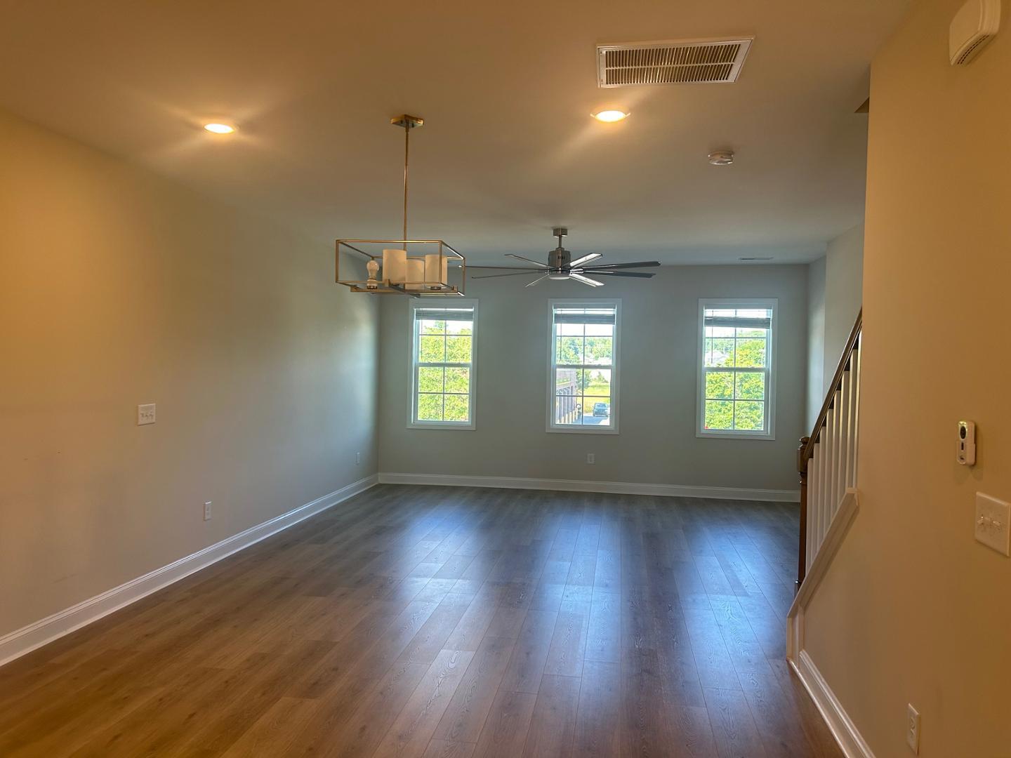 1024 Gateway Commons Circle Wake Forest, NC 27587 - Photo 10 of 18 a view of a room with wooden floor and windows