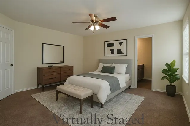 a bedroom with a bed and ceiling fan